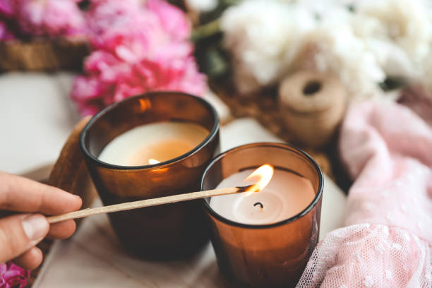 istock Match in hand lights a candle, atmospheric photo 1519976895