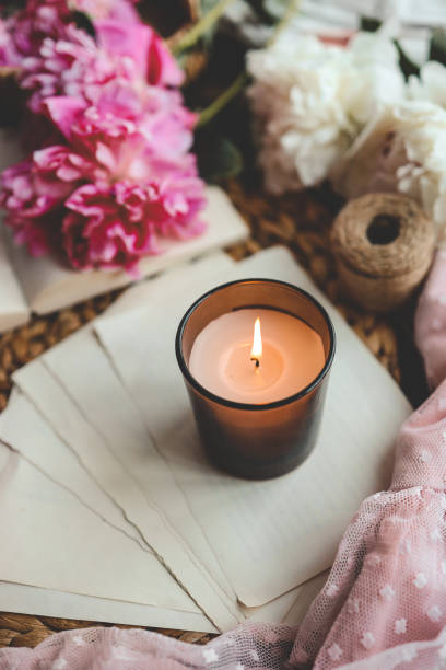 istock Cozy spring composition, burning candle, peonies and hat 1519976903