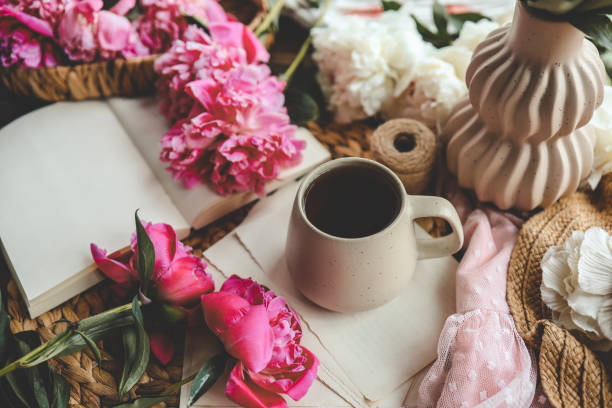istock Beautiful spring composition, good morning concept. Cup of tea, peonies and open book 1519977474
