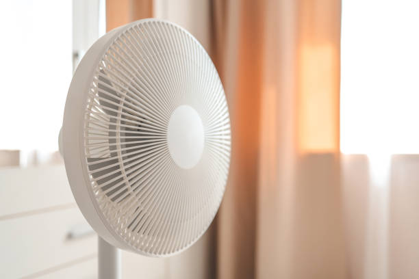 istock White desktop electric fan on light white room. Minimal concept with copy space 1519982206