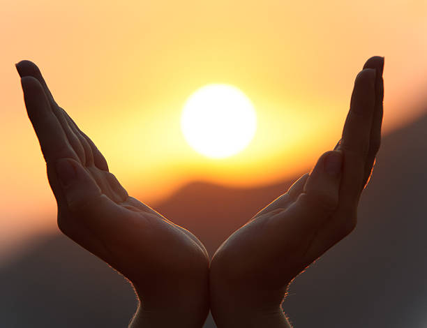 istock A pair of hands framing the sun during a sunset 151999368
