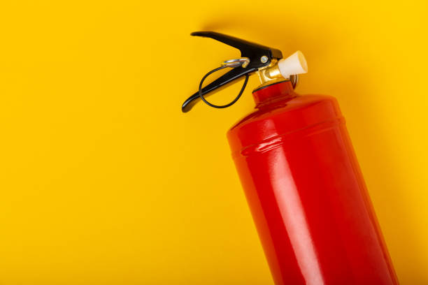istock Fire extinguisher on a yellow background. Fire protection, home fire extinguisher. home security concept. Place for text. Copy space. 1519993819