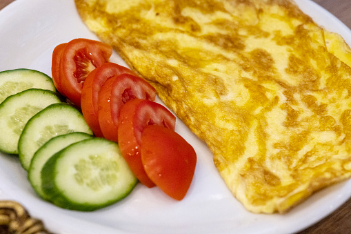 Delicious Omelette with cucumber and tomatoes.