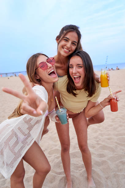 istock Three female friends having fun together at the beach. 1520062853