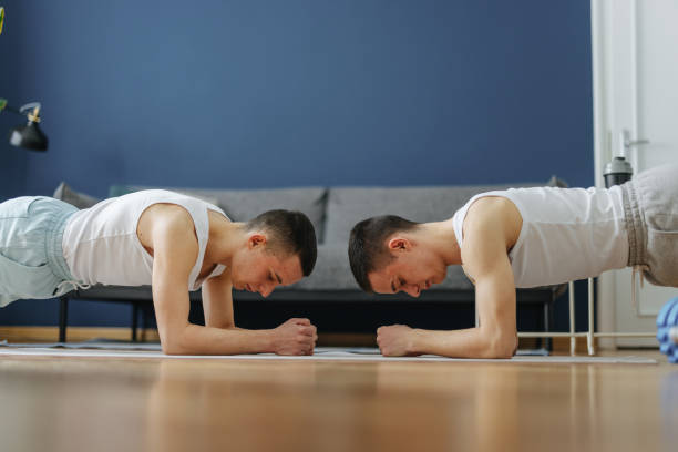 istock Twin Brothers Doing Home Workout Together 1520068669