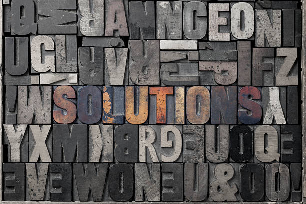Word solutions in color - solution concept The word solutions written out in old letterpress blocks. typescript print letterpress block stock pictures, royalty-free photos & images