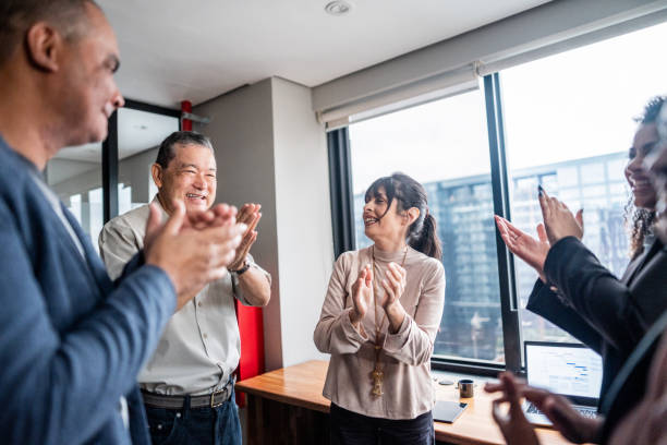 istock Coworkers celebrating at office 1520147845