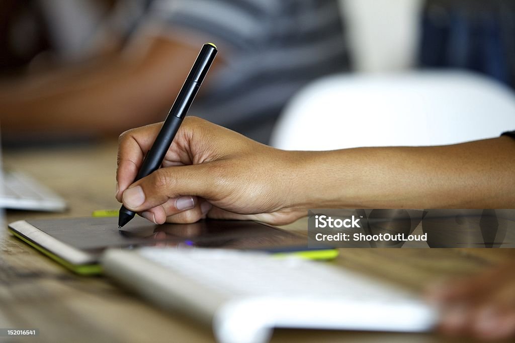 Graphic designer using tablet hand of a graphic designers while using a stylus. Pen Stock Photo