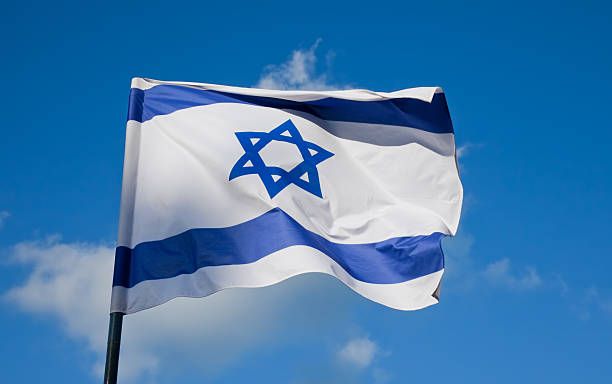 Israeli flag flying on a flagpole Flag of Israel, depicts a blue Star of David on a white background, between two horizontal blue stripes. israeli flag photos stock pictures, royalty-free photos & images