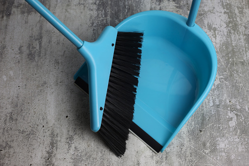 Broom with brush and dustpan. Blue plastic kit for cleaning trash and waste. House cleaning