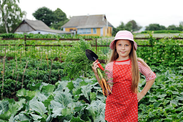 Girl working in garden stock photo