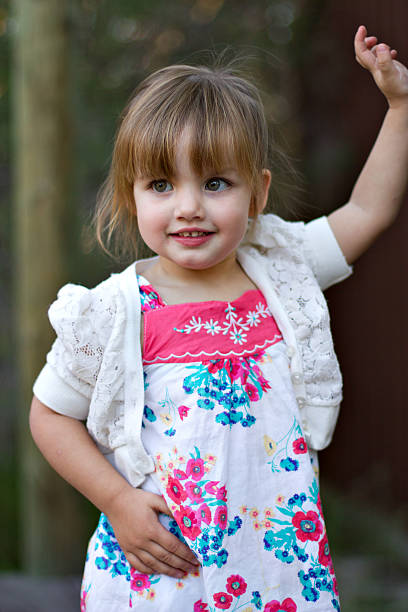 Outdoor location of cute toddler girl posing stock photo