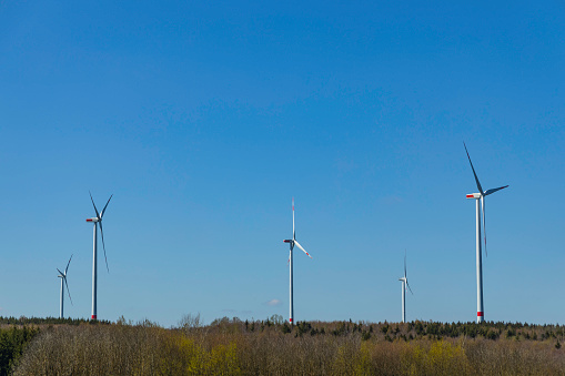 beautiful landscape with wind turbine against blue sky
