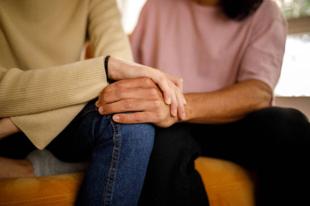 istock People holding hands for emotional support through hard times 1520209857