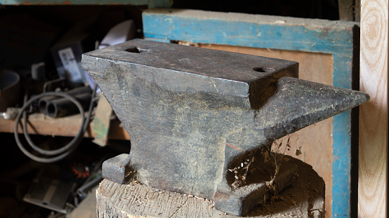 Metal anvil with black background, 3d rendering. Computer digital drawing.