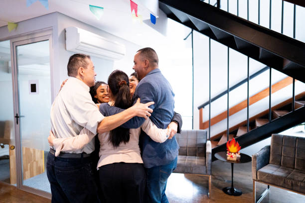 istock Coworkers embracing and celebrating at office 1520219888