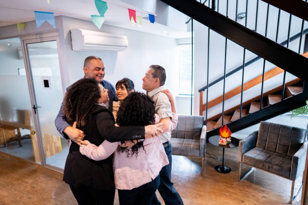 istock Coworkers embracing and celebrating at office 1520219892