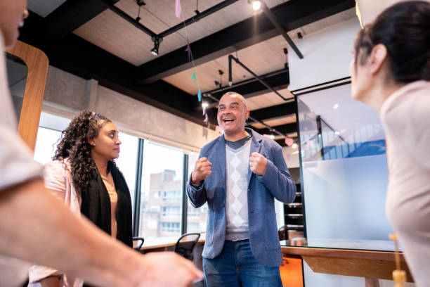 istock Coworkers celebrating at office 1520222063