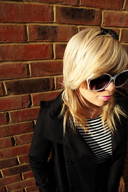 istock Young woman leaning against wall 152023601