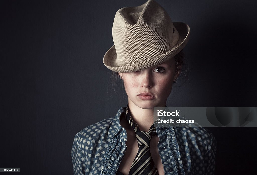 Woman in hat and tie portrait Woman in hat and tie portrait. On dark wall background. 20-29 Years Stock Photo