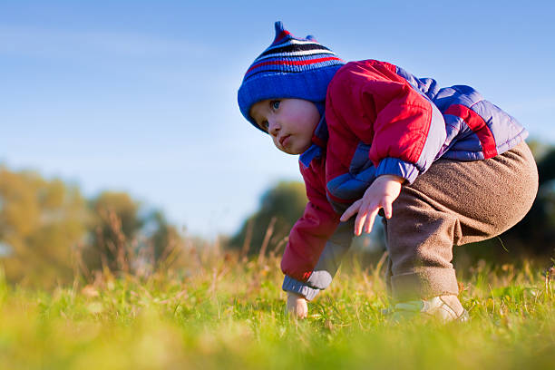 istock Little cute boy making his first steps on the grass 152024663