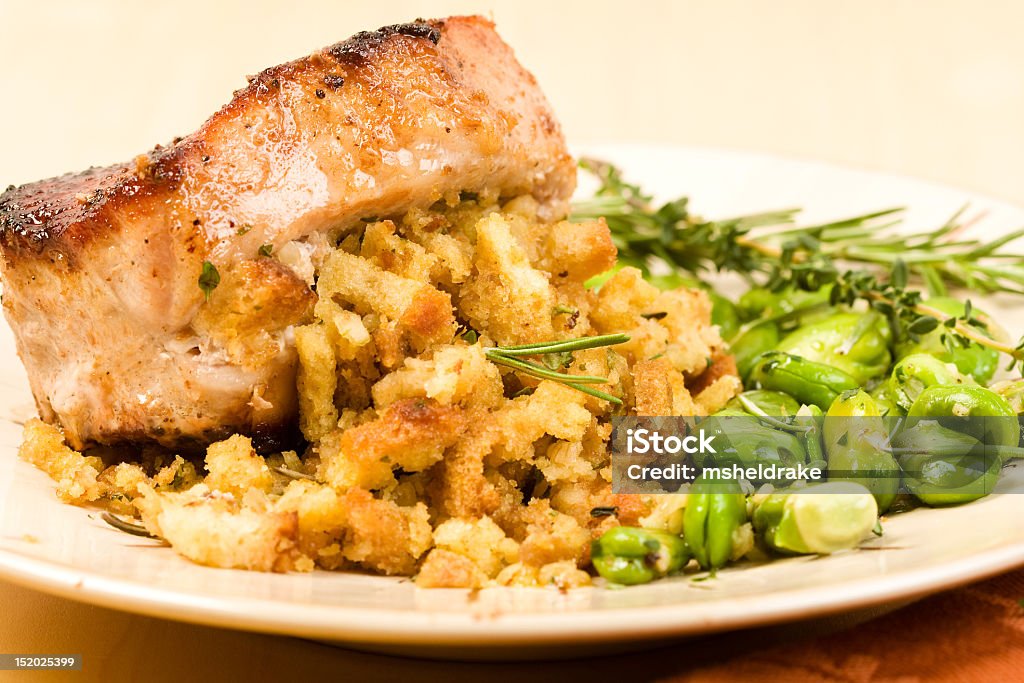 A plate with stuffed pork chop on a white plate Stuffed pork chop served with fava beans Stuffed Stock Photo