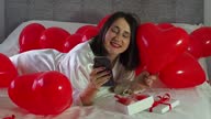 istock Woman lying in decorations with balloons for Valentines Day party 1520254908