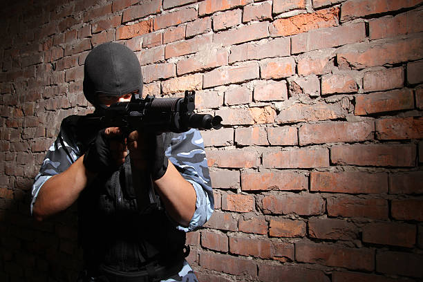 istock Soldier in black mask targeting with a gun 152025502