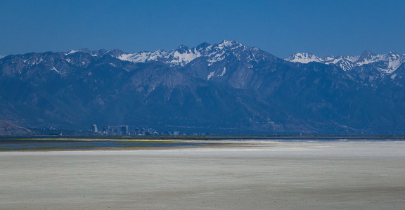 Salt Lake City in the far distance seen from across the mostly dry bed of Great Salt Lake from Antelope Island.