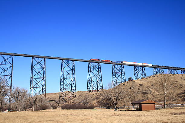 train crossing high level bridge a train crossing the high level bridge at Lethbridge, Alberta, Canada  This bridge is the highest and longest (the combination of the two) train bridge in the world.  It spans the coulee and the Old Man River. lethbridge alberta stock pictures, royalty-free photos & images