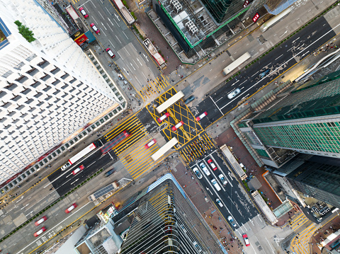Cityscape skyscraper buildings, car traffic transport on road in Mong Kok town district, Hong Kong downtown. Drone aerial top view. Asian people lifestyle, Asia city life or public transportation