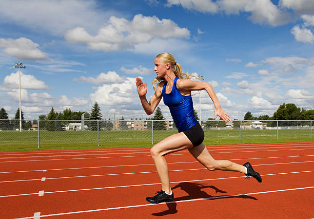 istock Side view of female athlete sprinting on track 152030347