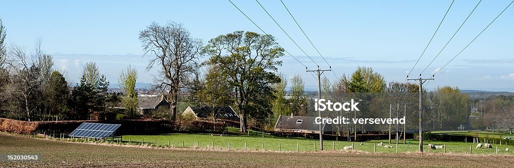 Solar panels feed the grid A photovoltaic solar panel in a field feeds local and national grids with free electricity. Agricultural Field Stock Photo