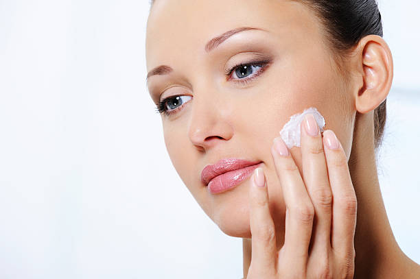 istock woman caring of her face with moisturizer cream 152030879
