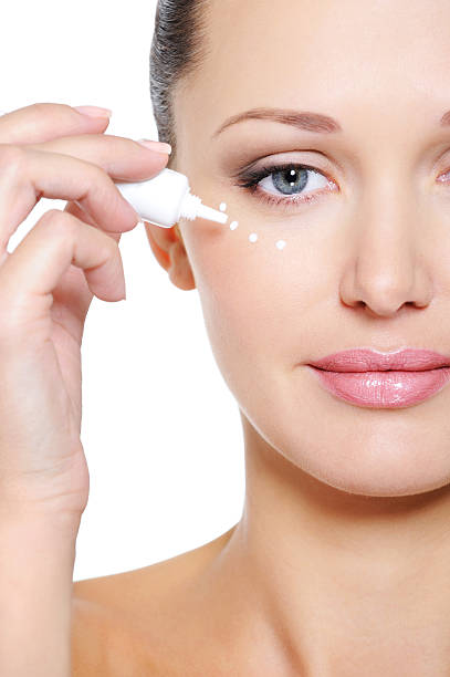 istock Woman applying moisturizer cosmetic on her eyelid 152030926