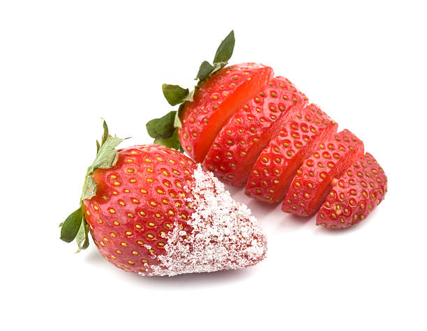 Strawberry - sliced and with sugar stock photo