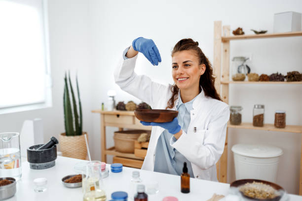 istock Young beautiful woman working with jojoba wax at her workshop 1520320014