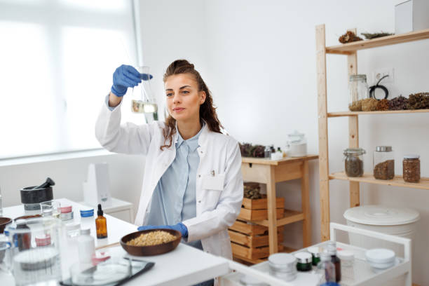 istock Young beautiful woman in lab coat working at workshop 1520320015