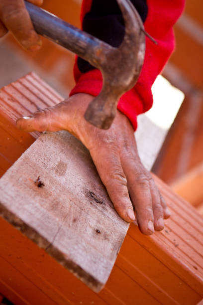 Bricklayer hammering a nail into wood - Buenos Aires - Argentina