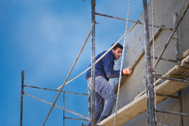 istock Construction worker placing cement with a trowel on the wall 1520326682