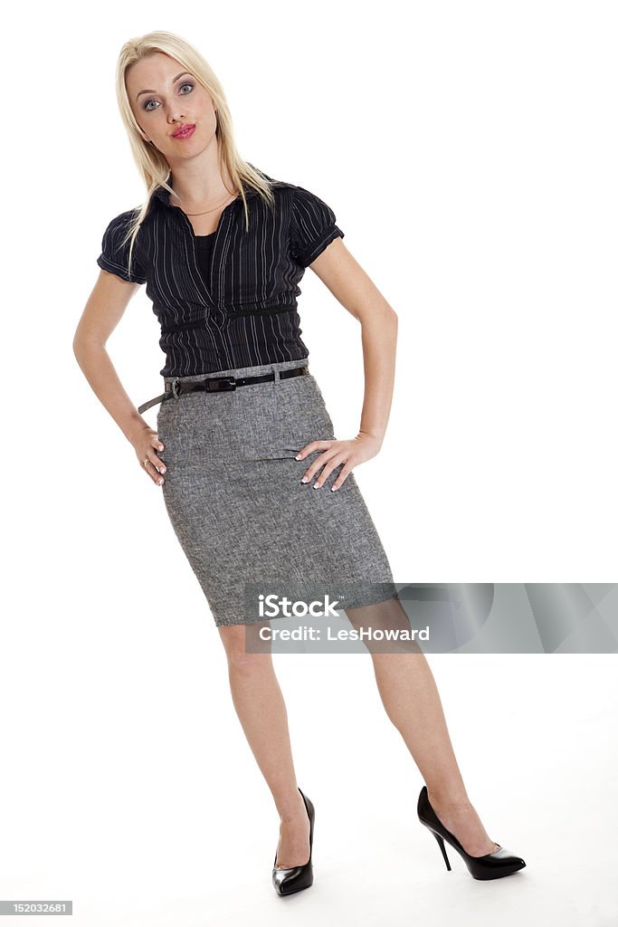 Attractive businesswoman in confrontational stance An attractive, young, blond businesswoman stands with hands on hips in a confrontational or challenging stance, isolated on white. Arms Akimbo Stock Photo