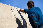 Construction worker placing cement with a trowel on the wall