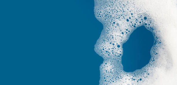istock Detergent foam bubble on water. Blue background, Soap sud 1520352078