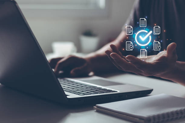 istock Document management DMS System Digital rights management. Businessmen hand show virtual glowing correct sign mark and document for online approve paperless and quality assurance concept. 1520359892