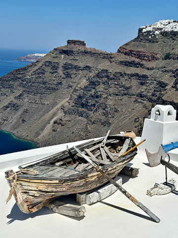 Stunning view of the Aegean Sea from rooftop with worn boat and oars on it