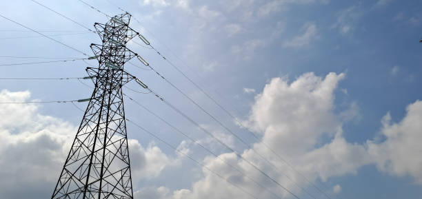 istock High voltage electric tower background of blue sky with clouds 1520443856