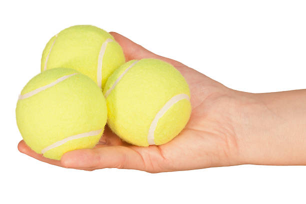 istock Tennis balls in hand 152044888