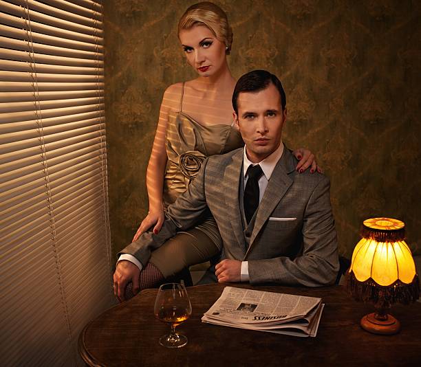 istock A retro man and woman couple sitting behind a table 152046242