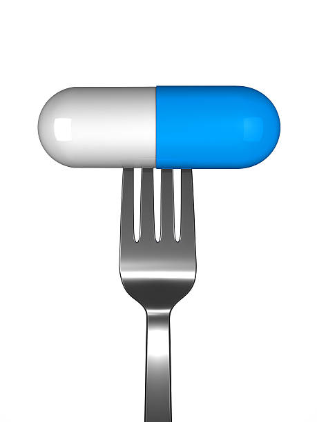 pill on fork stock photo