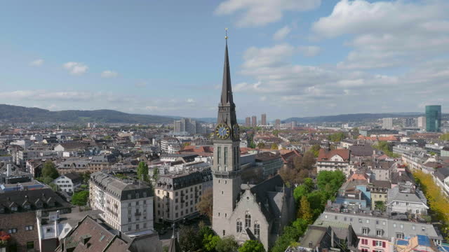 sunny day zurich city center famous church clock tower front exterior aerial panorama 4k switzerland